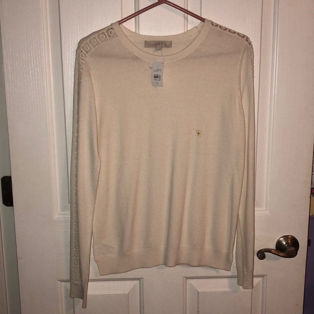 Long sleeve white sweater.